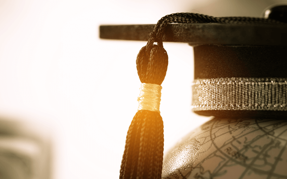 Graduation cap placed on world globe