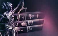 Lady Justice placed in front of a stack of books.