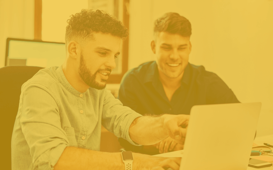 Two employees work together on an AI project.