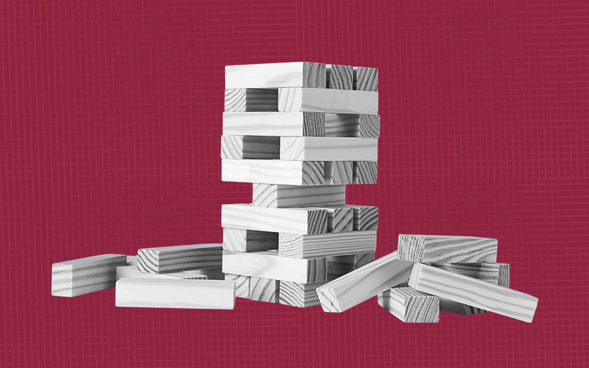A block tower that is partially knocked over.