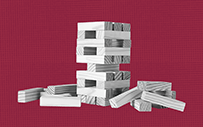 A block tower that is partially knocked over.