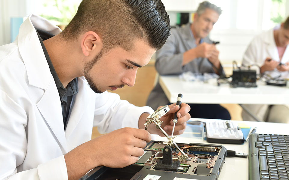 A computer science student works on some hardware.