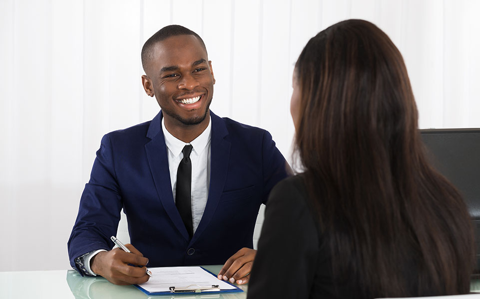 An HR manager discusses the benefits package with a potential intern.