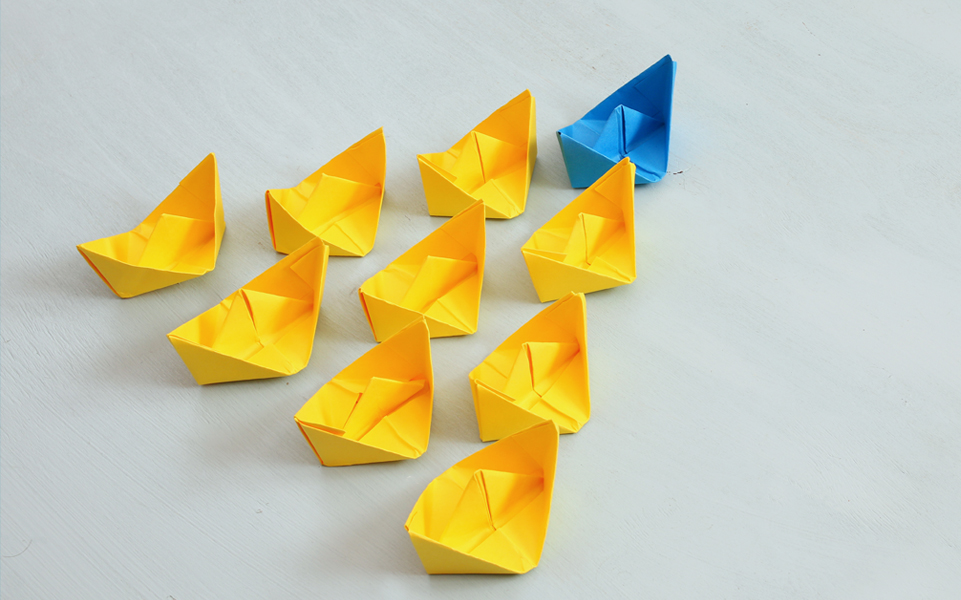 Rows of paper folded into origami shapes.