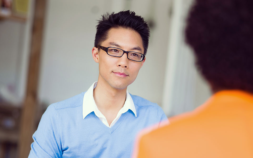 A university relations and recruiting professional interviews a recent college graduate.