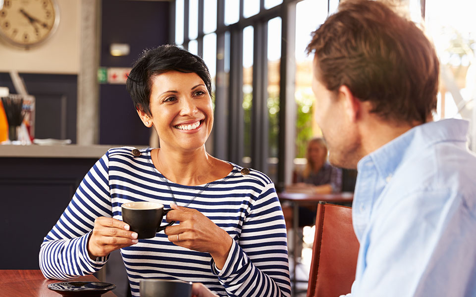 A recruiter meets with an advanced degree student at a coffee shop.