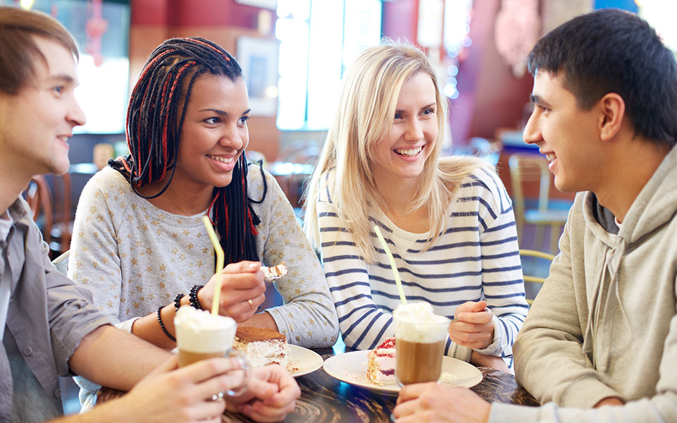A group of college students attend a casual meetup at a local coffee shop to discuss their career development.