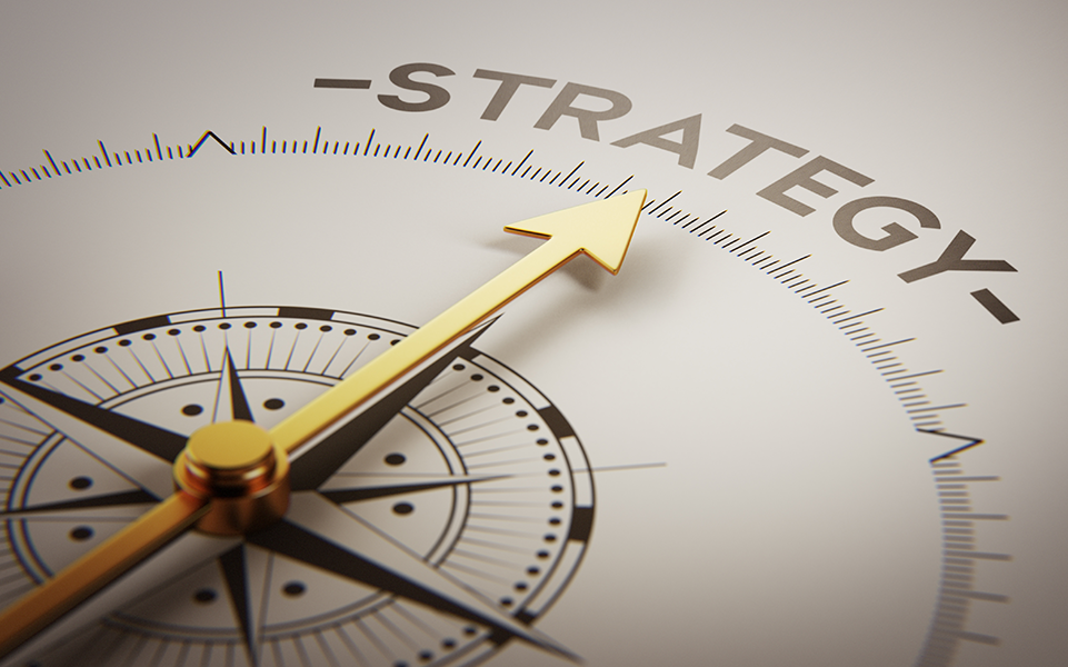 A compass points to the word strategy.