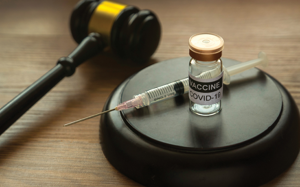 A vaccine vial and a gavel.