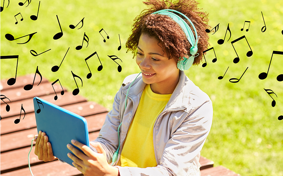 A student listens to some music on her headphones.