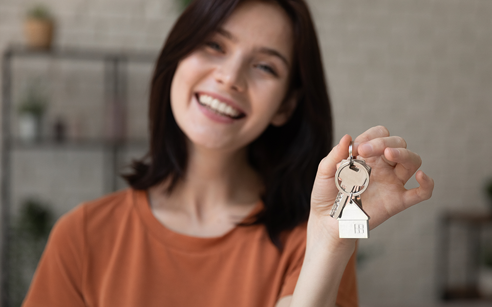 A landlord hands over the keys to an apartment.